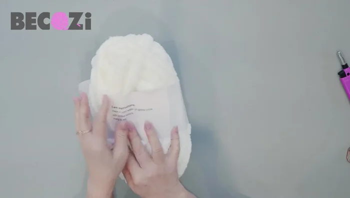 Casting on: Begin with 14 stitches (12 for a shorter shaw). Burn the yarn end to prevent unraveling. Make a loop, insert your hand, grab the working yarn, and pull it through the loop. Pull down both working yarn and tail, then pull the first stitch up to tighten.