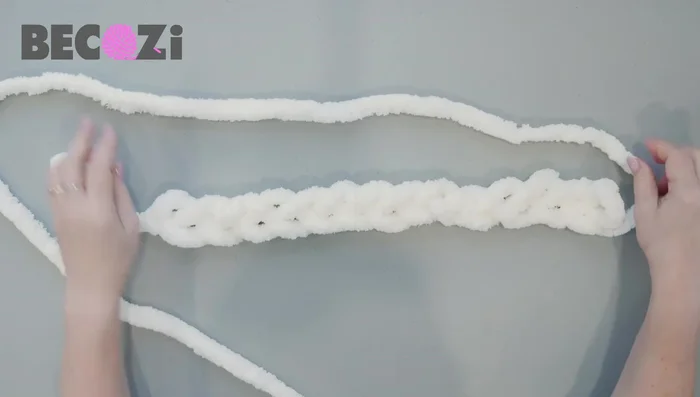 Knitting the first row: Flip the work. Knit across all stitches (14 or 12), maintaining consistent stitch size. Right-handed knitters use their right hand from right to left. Left-handed knitters adapt accordingly, using their left hand.