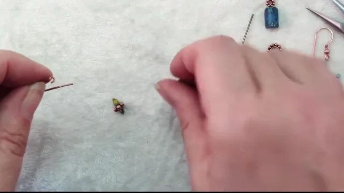 Attach the ear wire: Open the loop of the ear wire and slide it onto the earring assembly (177.88).