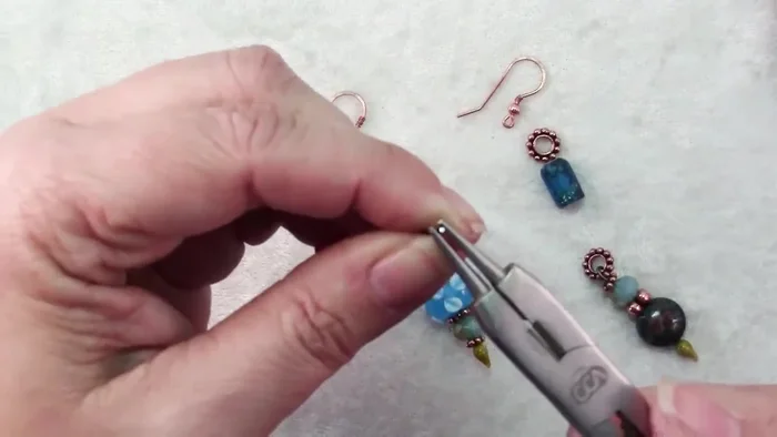 Final adjustments: Add seed beads or make other minor adjustments to achieve the desired look (247.09).