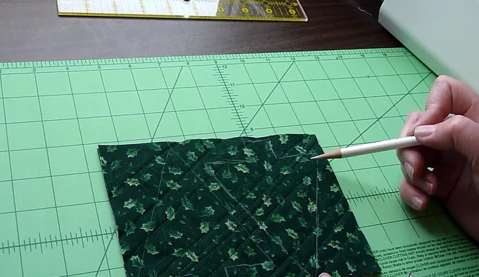 Stitch the ornament shape: Stitch a 1/4-inch seam inside the traced lines. Remember to pivot at the corners. At the top, leave a small opening for the ribbon.