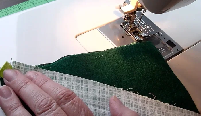 Complete the patchwork: Continue adding fabric strips until you reach the corner. Fold and flip the last piece to create a seamless edge.