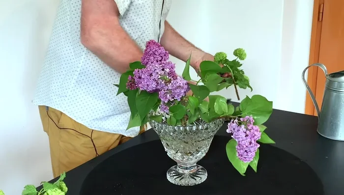 Add supporting materials: Arrange other flowers (e.g., viburnum, roses, tulips) around the larger ones, strategically using the various-sized holes. This builds a strong and visually appealing framework.