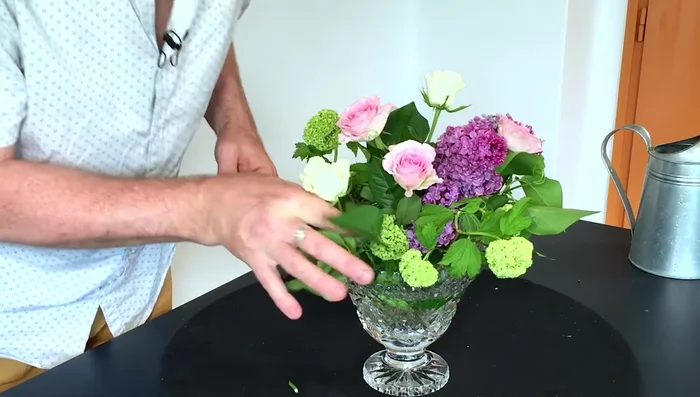 Fill in with smaller flowers: Add smaller flowers and foliage to create a fuller, more cohesive arrangement. Adjust heights and positions as needed.