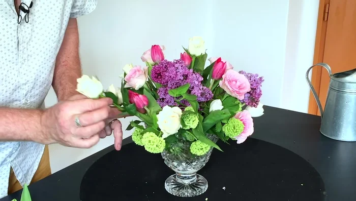 Optional: Use leftover flower heads: Create a smaller arrangement with leftover flower heads by placing them in a small dish with water next to the main arrangement.