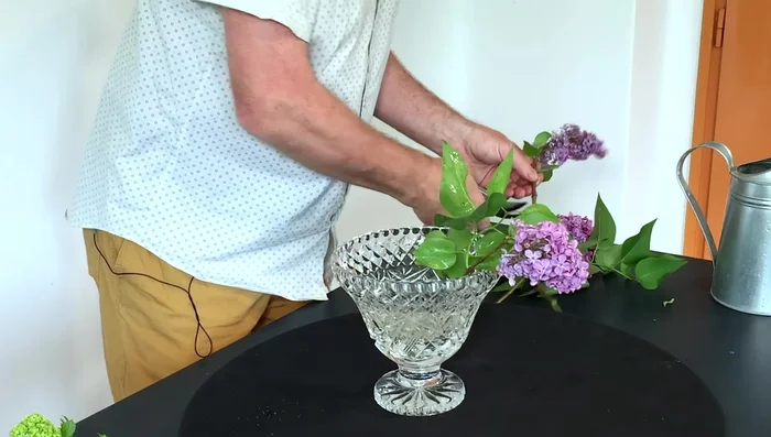 Prepare the flowers: Use a sharp knife to cut the stems of your larger flowers (e.g., lilacs). This provides a clean cut compared to scissors. 