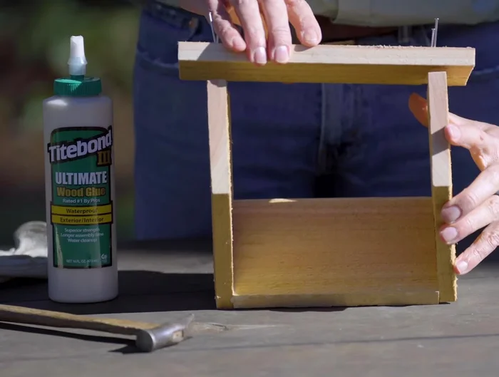 Attach the narrow roof piece, followed by the wider roof piece.