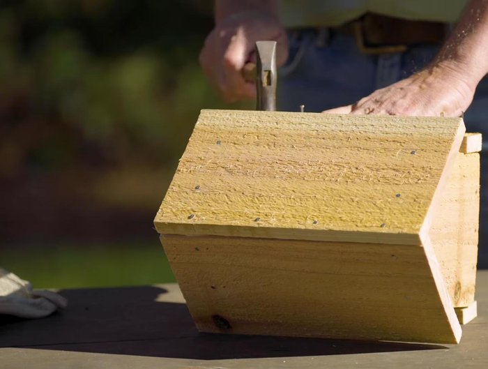 Attach a cedar strip along each side of the feeder.