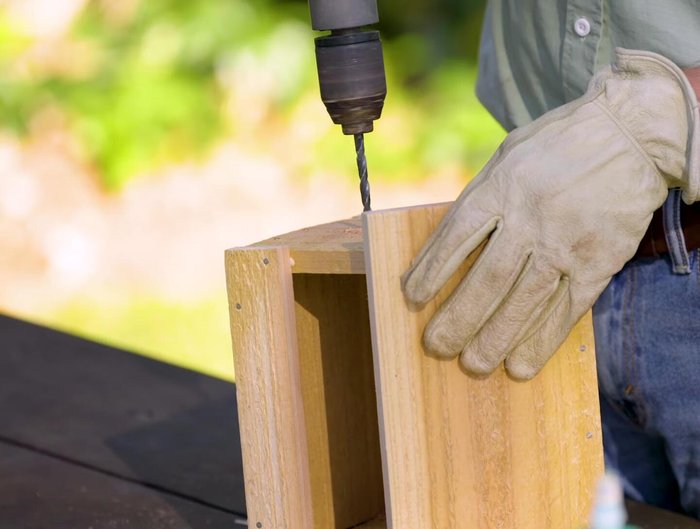 Apply wood glue and tap the dowel rod (perch) into the smaller holes. Wipe away excess glue.