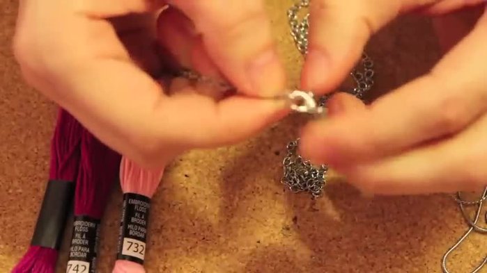 Tie another knot at the end to secure the floss.