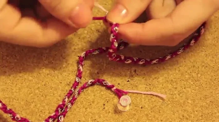 Continue braiding until the desired length is reached, then tie another knot.