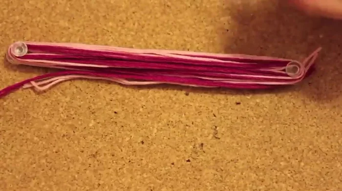 Tie a knot to secure the tassel to the necklace at the longer end, and repeat for the other end.