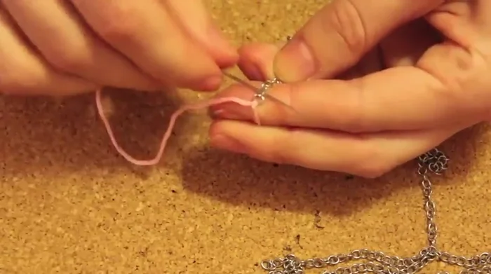 Tie another knot at the end to secure the floss.