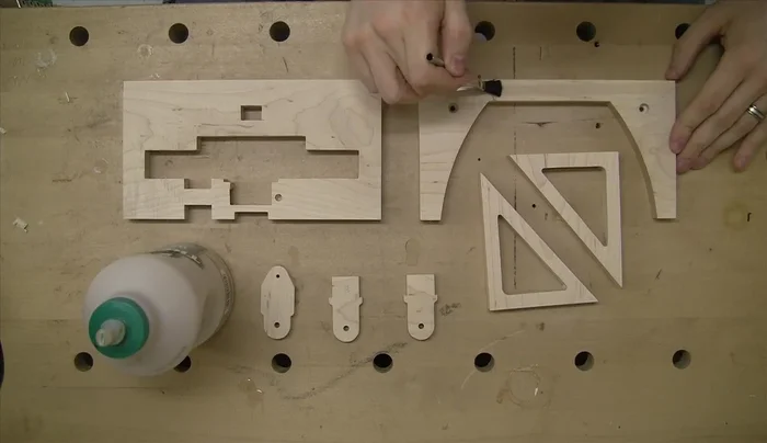 Polish the brass shafts before pressing them into the rear vertical frame using an arbor press and dead blow hammer.