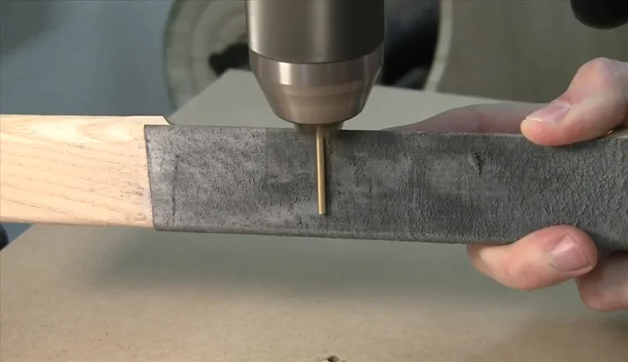 Polish the brass shafts before pressing them into the rear vertical frame using an arbor press and dead blow hammer.