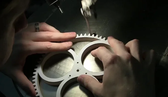 Drill holes and countersinks for the cannon pinion, ensuring concentricity.