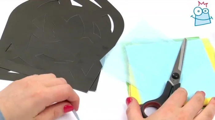 Pop out the partially cut shapes from one of the cardboard pieces using your fingers.