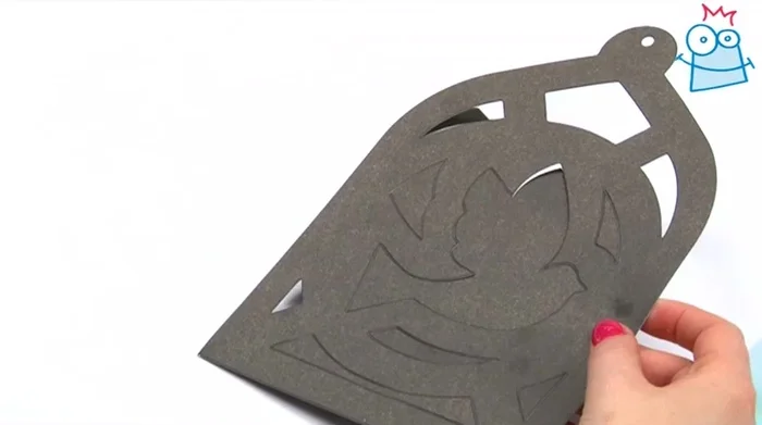 Pop out the partially cut shapes from one of the cardboard pieces using your fingers.