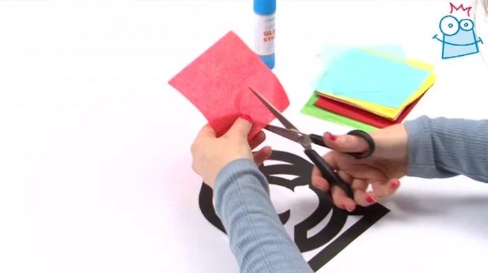 Apply glue around the edge of a shape and press the tissue paper onto it. Repeat for all shapes, ensuring the tissue paper covers the shape completely.