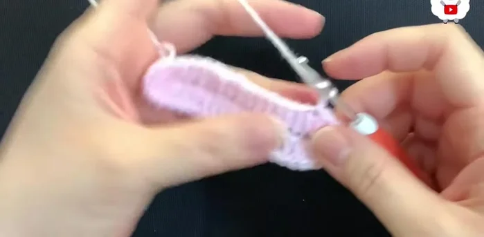 Chain 2 for the second row (chains don't count as double crochets). Make 14 double crochets, then 2 double crochets on each of the next 7 double crochets. Repeat for the other side, ending with 14 double crochets and joining with a slip stitch (total of 56 double crochets).