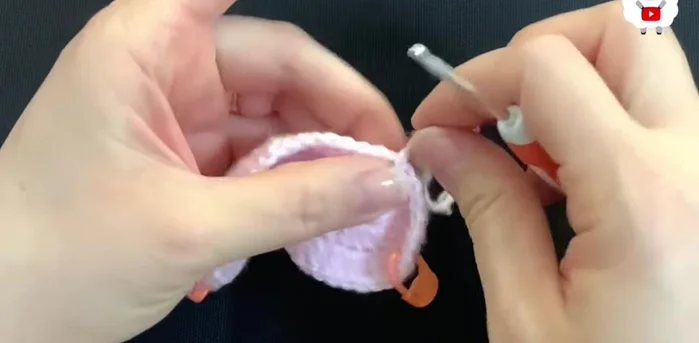 Insert hook into the stitch, grab a loop, and bring it through the front. Chain 2 (these chains don't count as stitches). Make double crochets around, joining to the first double crochet (not chains) of each section. You should end with 56 double crochets.