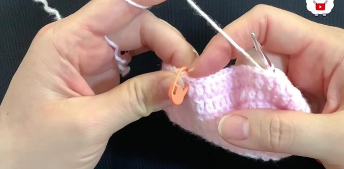 For the fifth row, chain 2. Work 10 double crochets, reduce stitches in the next four, work 14 double crochets, reduce stitches in the next four, and finish with 10 double crochets (30 double crochets).