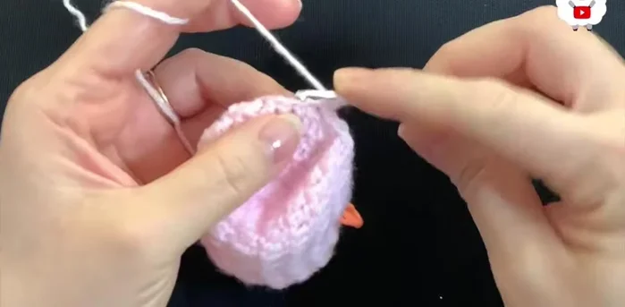 For the fifth row, chain 2. Work 10 double crochets, reduce stitches in the next four, work 14 double crochets, reduce stitches in the next four, and finish with 10 double crochets (30 double crochets).