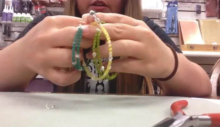 Secure the braid by closing a large jump ring through all three strands.