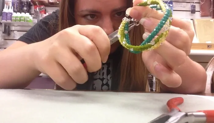 Secure the braid by closing a large jump ring through all three strands.