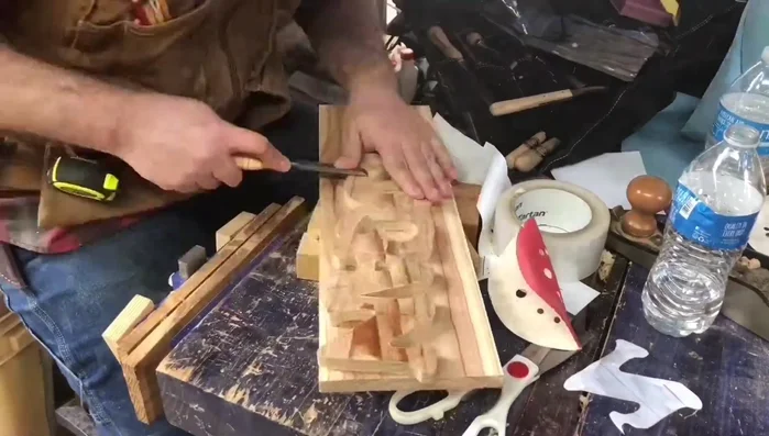 Carve or sand shadow lines where letters overlap to create a 3D effect. Sand the edges of the nameplate to make them smooth.