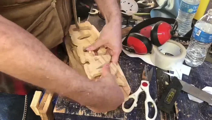 Drill holes for dowels in both the nameplate and the backdrop. Glue the dowels into the nameplate only.