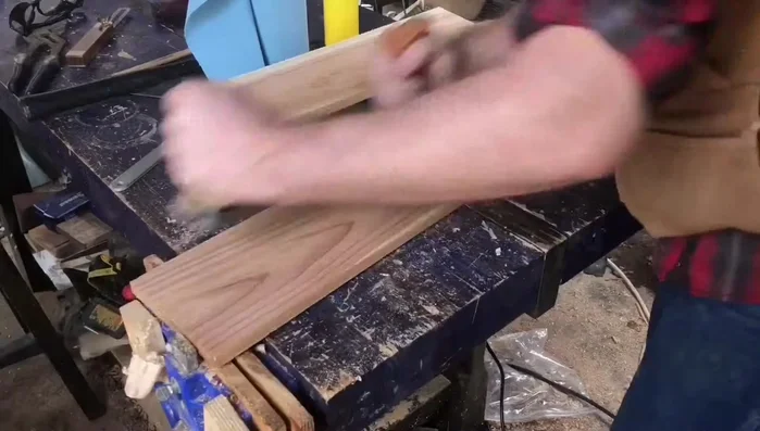 Flatten the board using a plane or thickness planer. If you don't have these tools, buy a pre-flattened board and sand it smooth.