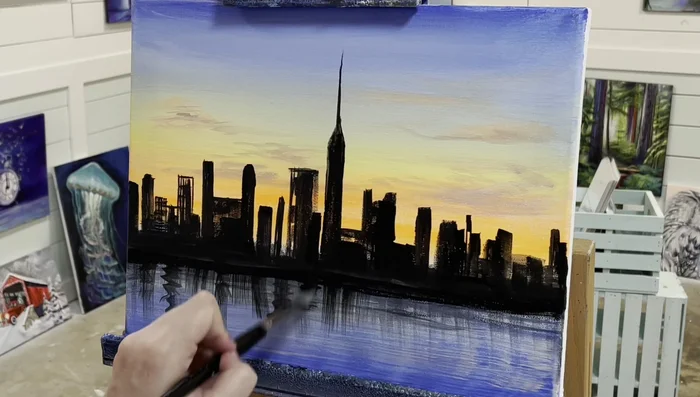 Add reflections and shadows in the water using black paint, using flicks and drags to create movement.