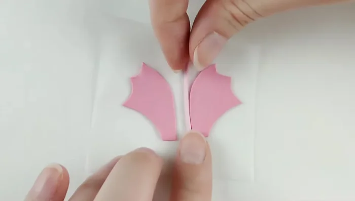 Create wings with a long curve shape. Add details to both sides. Pre-bake. Attach wings to the body. Freeze dragon to prevent shape disturbance when attaching wings.