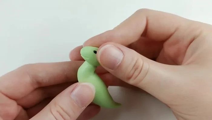 Attach the head to the body using liquid Sculpey, blending with a sculpting tool.