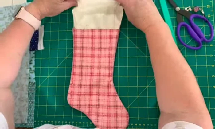 Hem the top using hand stitching, machine stitching, or hemming tape.