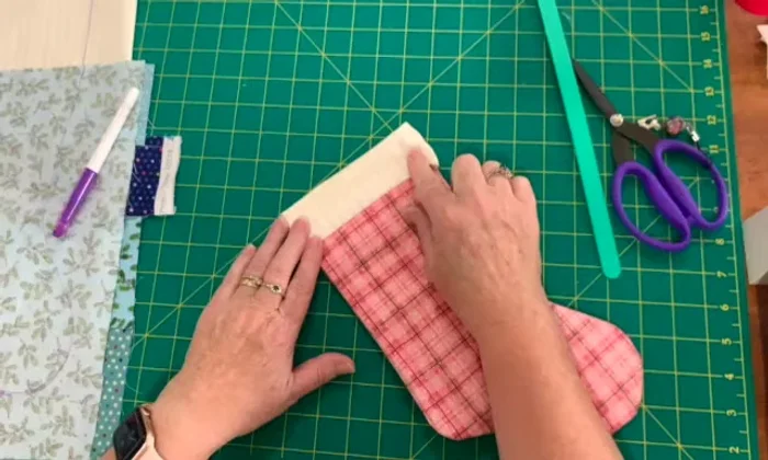 Hem the top using hand stitching, machine stitching, or hemming tape.