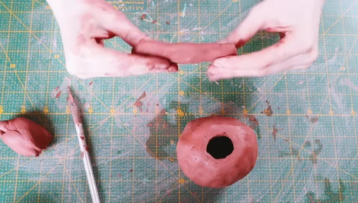 Score the top of the vase and the neck, then attach the neck with water, blending thoroughly.