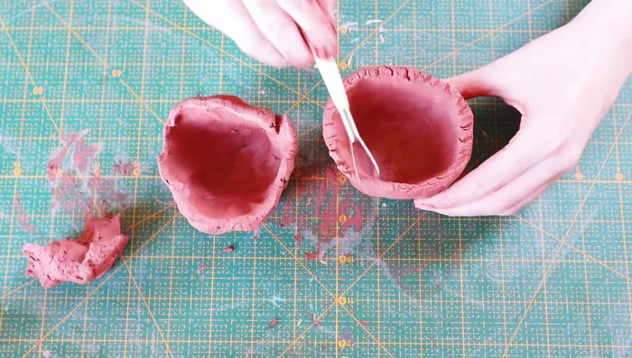 Add arms by shaping small pieces of clay, scoring contact points, and blending.