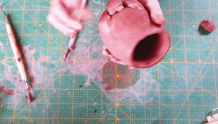 Create a small orange friend by rolling a ball and adding leaves.