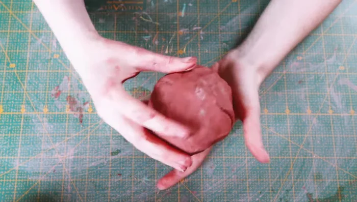 Score the lips of both bowls and stick them together, blending the seams.