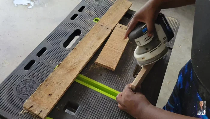 Sand the pallet wood thoroughly using 80 grit sandpaper to achieve a smooth surface, removing splinters and roughness.