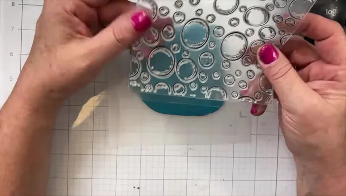 Imprint your design: Use clear cling stamps to create impressions in your clay. If the clay is sticky, lightly spray with water.