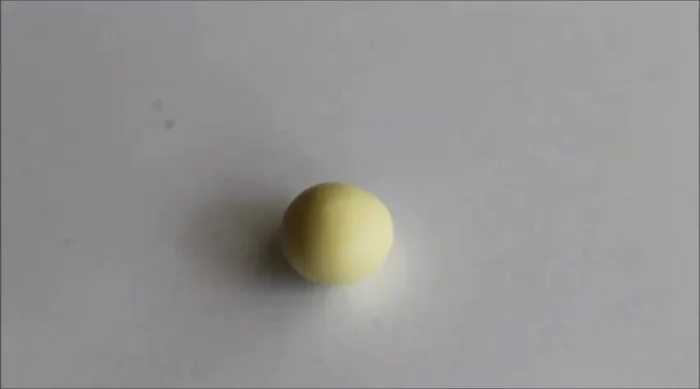 Roll your clay into a ball and flatten it into a circle.