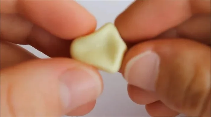 Rotate the shape and push in the long bit with your thumb to form a rough star shape.