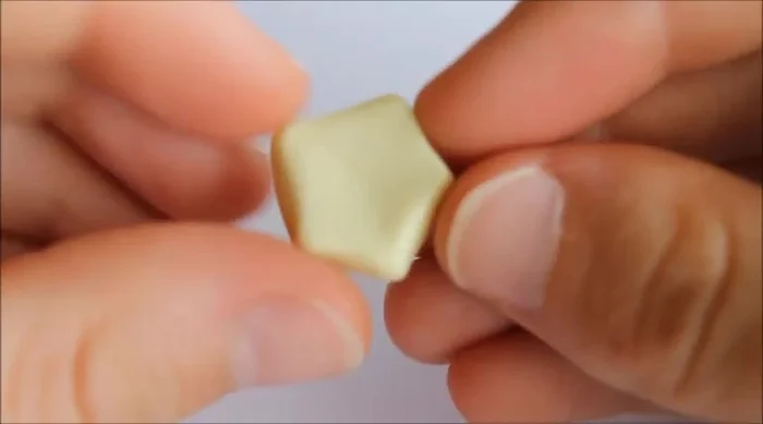 Round the edges by pushing and smoothing them out to make the star more plump.