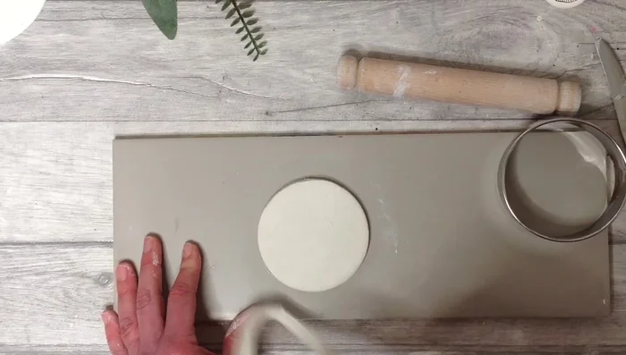 Use the score and slip method to attach the base and clay slab.