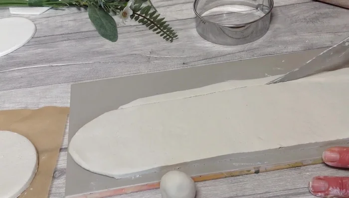 Use the score and slip method to attach the base and clay slab.