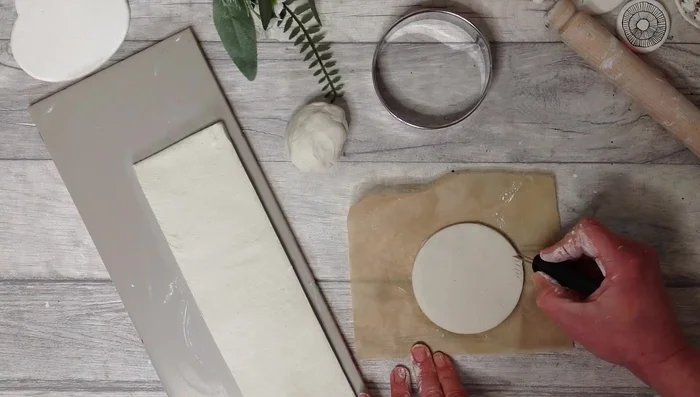 Use the score and slip method to attach the base and clay slab.