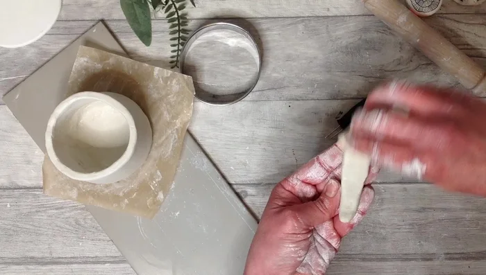 Create and attach a handle using the score and slip method.